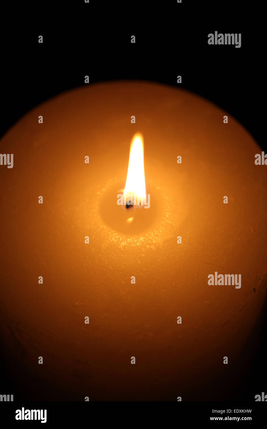 candle burning on a black background Stock Photo - Alamy