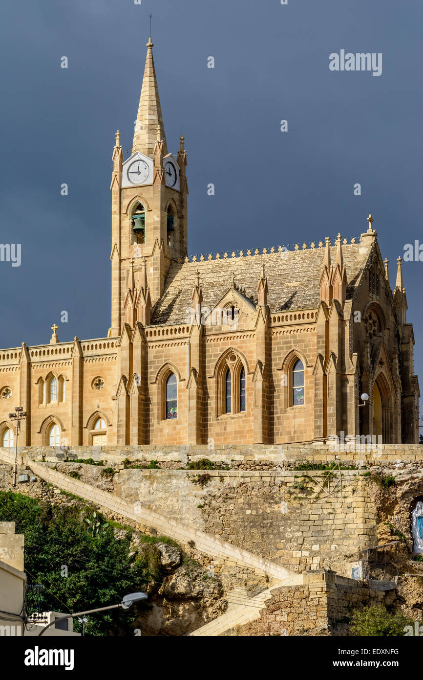 Lourdes Church, a neo-gothic monument built in 1888 on the coastal village of Mgarr on the island of Gozo, Malta Stock Photo