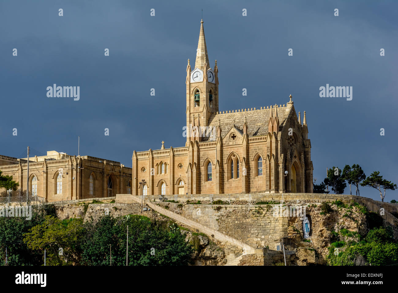 Lourdes Church, a neo-gothic monument built in 1888 on the coastal village of Mgarr on the island of Gozo, Malta Stock Photo