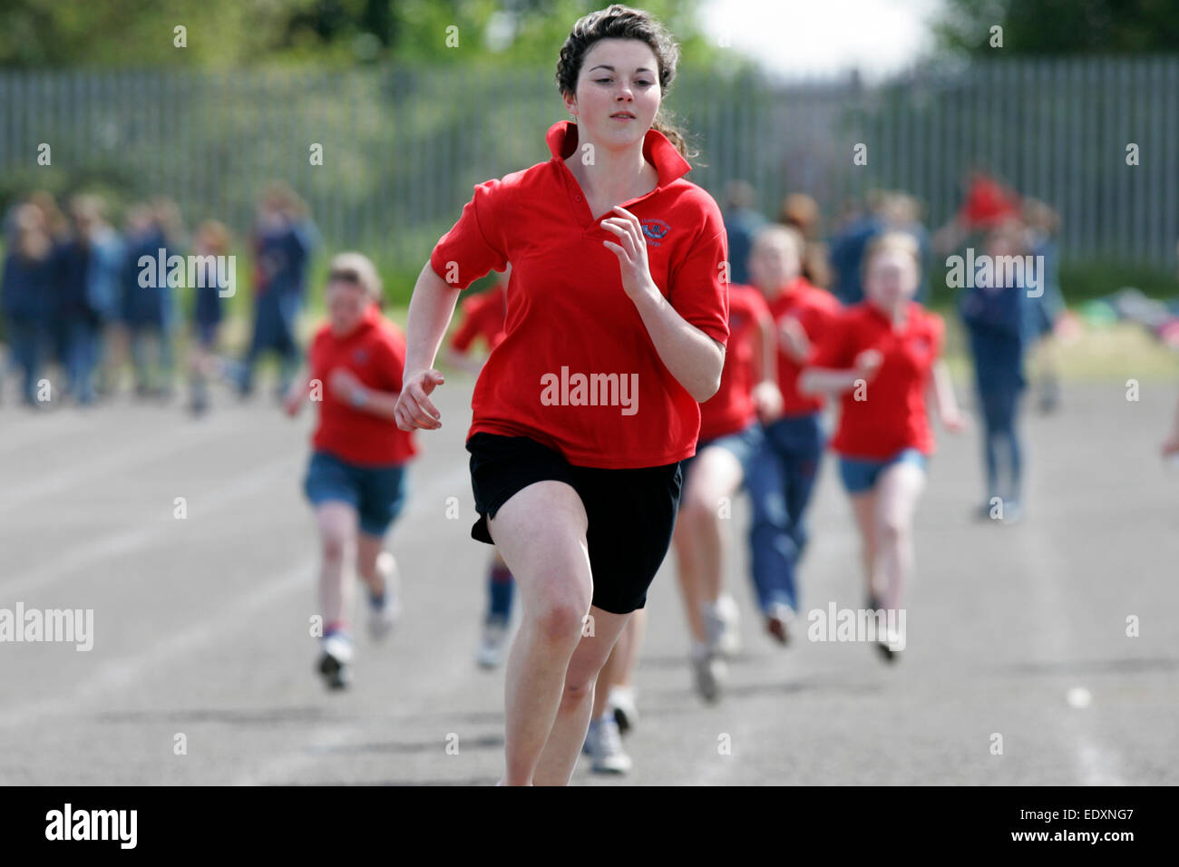 teenage girl running at a school sports day in the uk Stock Photo