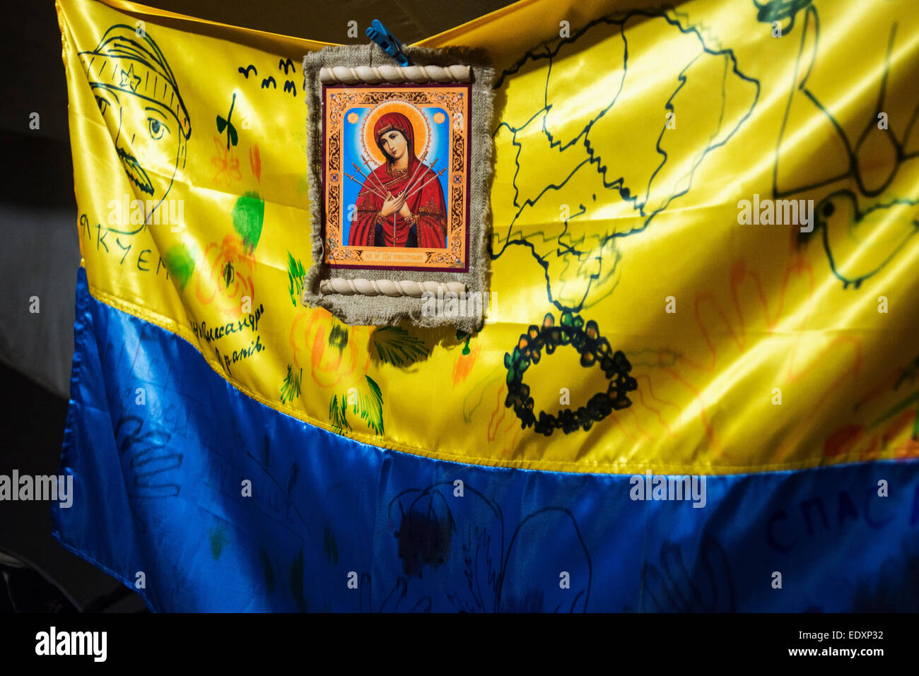 Donetsk Region, Ukraine. 09th Jan, 2015. Ukrainian national flag with Orthodox Christian icon in soldier's living tent at proving ground near ATO zone, Donetsk region, Ukraine © Oleksandr Rupeta/Alamy Live News Stock Photo