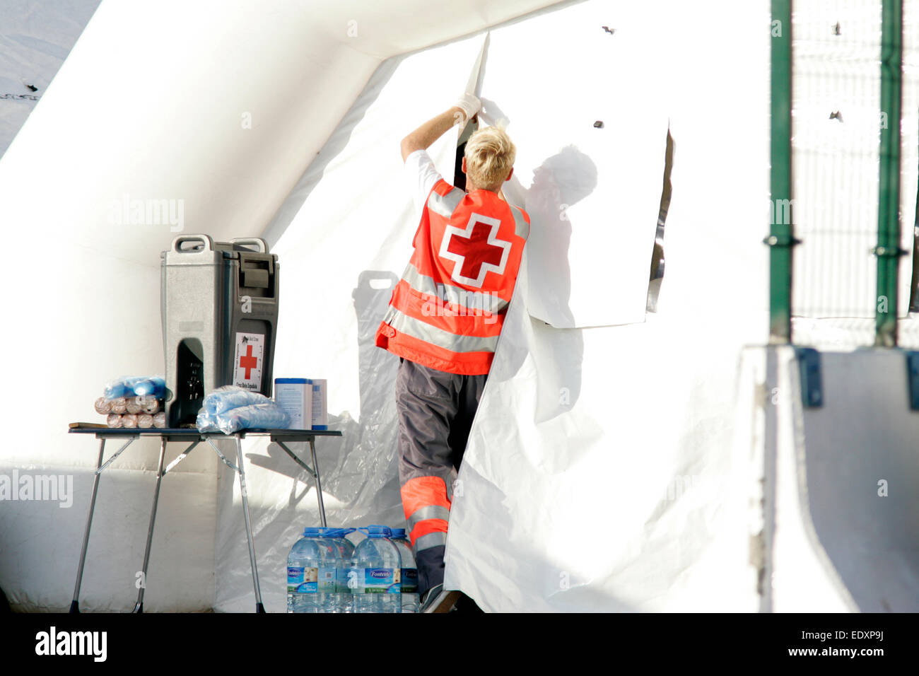spanish red cross worker closes up inflatable aid quarantine area used to decontaminate illegal african migrants Stock Photo