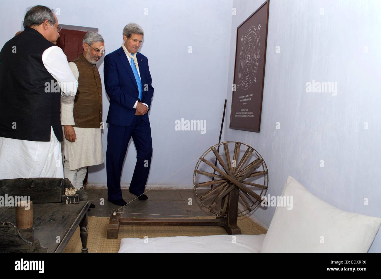 US Secretary of State John Kerry views the bed, desk, and spinning wheel used by Mohandas Gandhi during a visit to the Sabarmati Ashram, where Ghandi lived January 11, 2014 in Ahmedabad, India. Stock Photo
