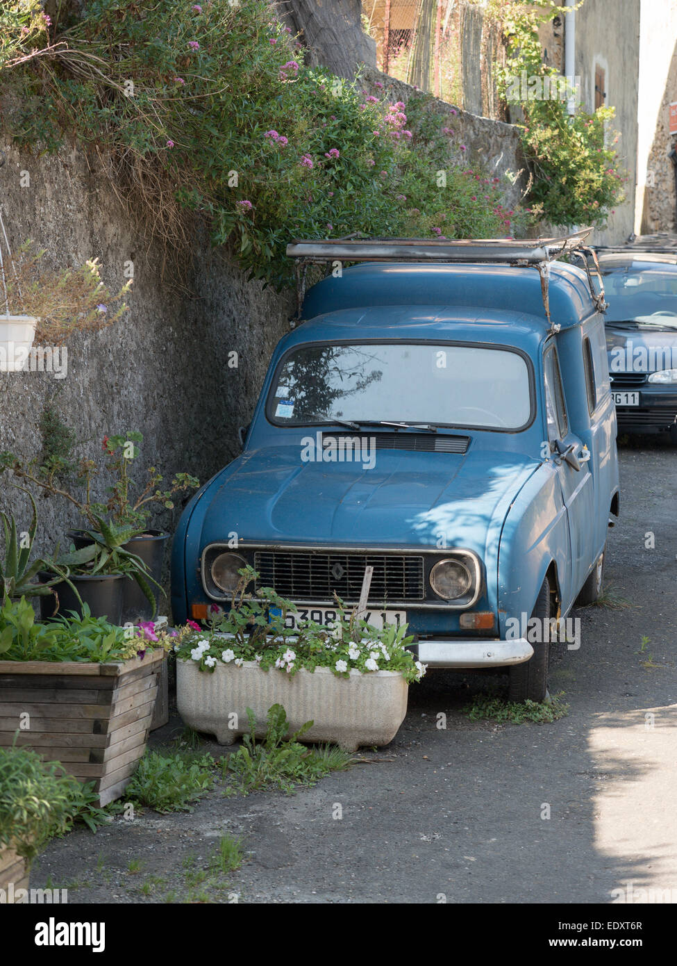An old blue Renault 4 with roof rack in the village of Bugarach southern France Stock Photo
