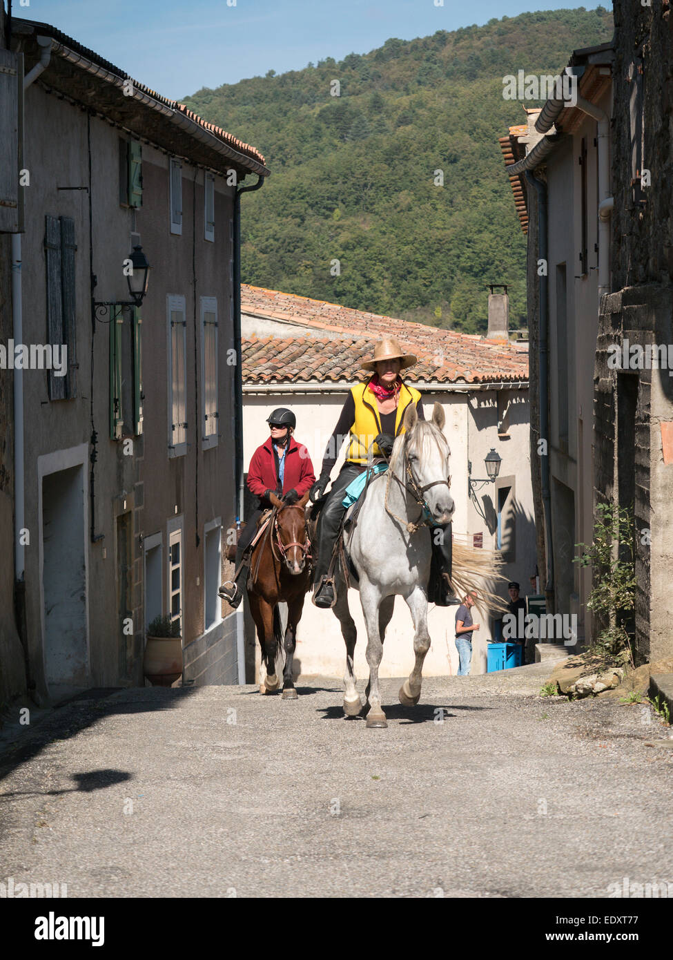 Horse riders in village of Bugarach in the Languedoc, France Stock Photo