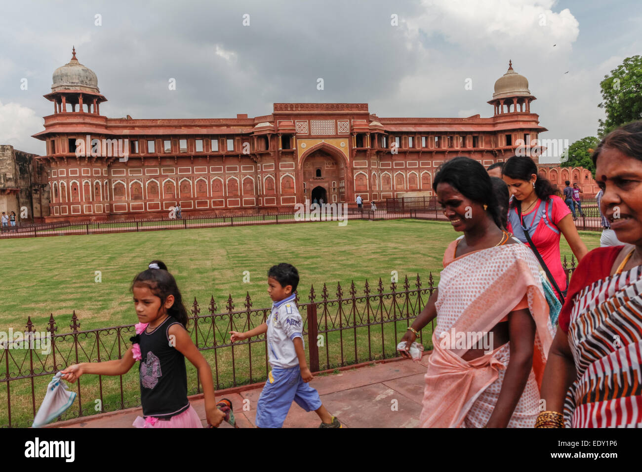 Women and children passing in front of  Jahangir Mahal, inside Agra Fort complex, Uttar Pradesh, India. Stock Photo
