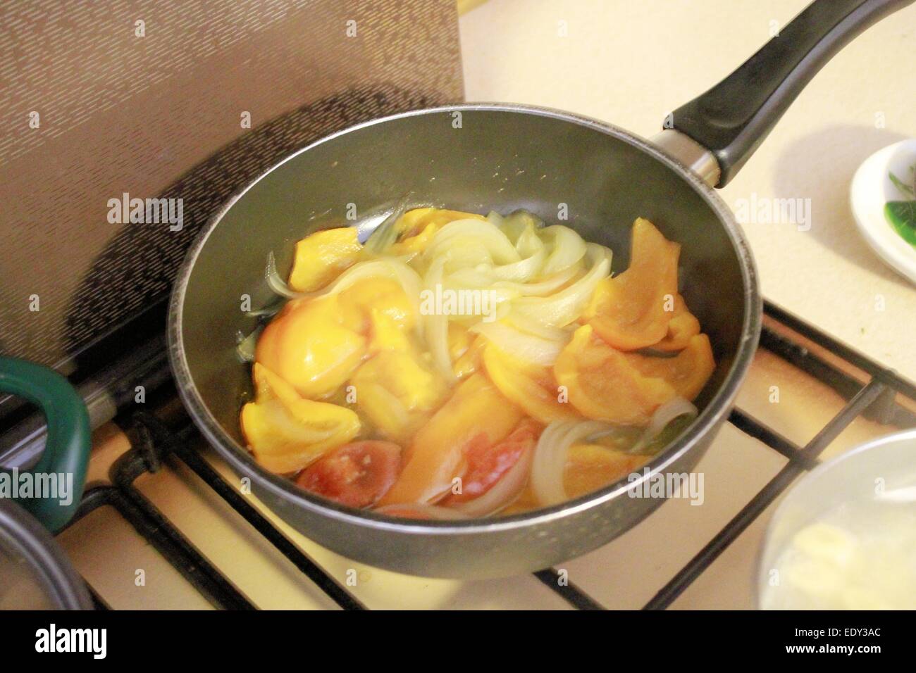 yellow peppers and onions in the pot Stock Photo Alamy