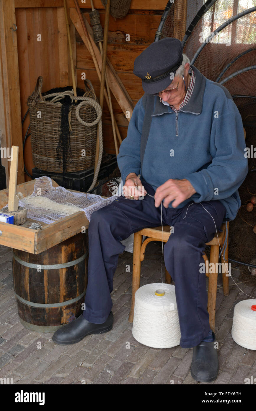 Man demonstrating traditional net making, Zuiderzee open air museum, Lake Ijssel, Enkhuizen, North Holland, Netherlands, Europe Stock Photo