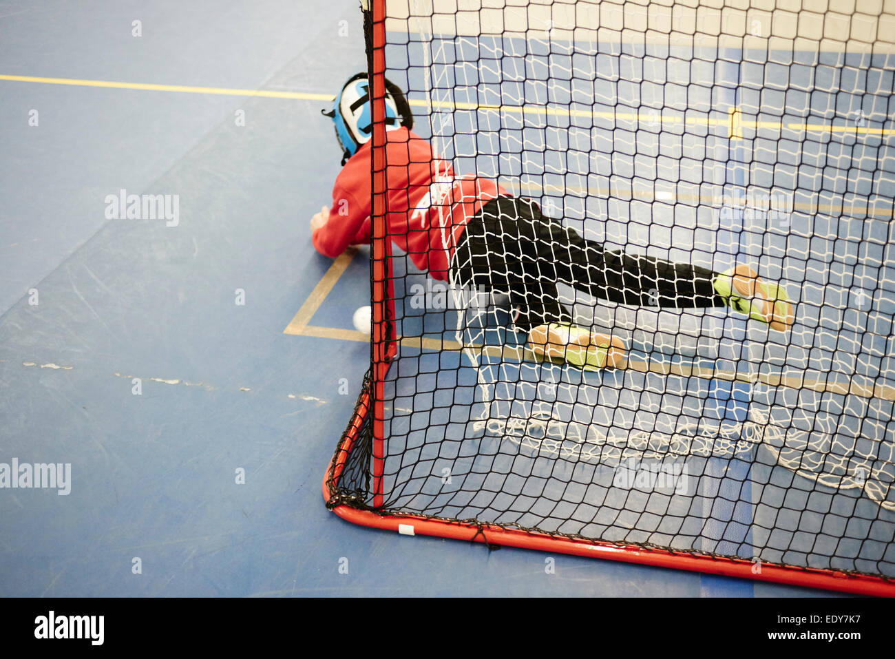 Children boys schoolchildren playing floorball (floor hockey) match in