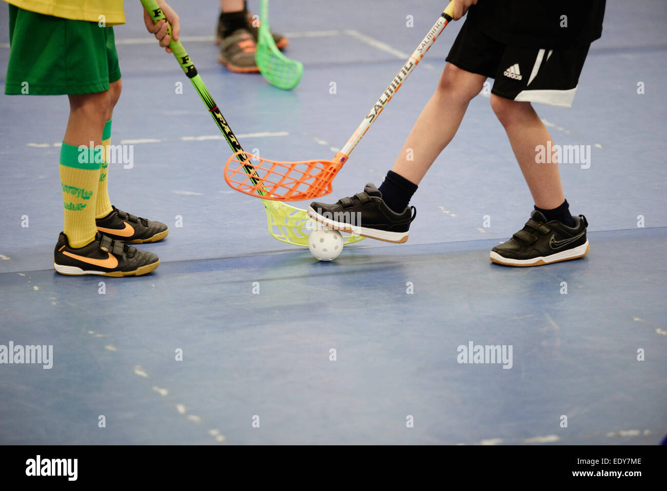 Children boys schoolchildren playing floorball (floor hockey) match in  school gym hall with plastic hockey sticks Stock Photo - Alamy
