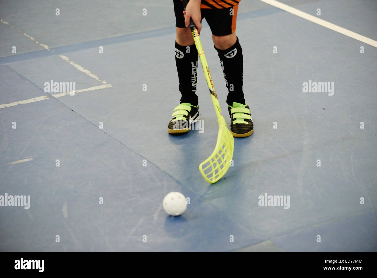 Children boys schoolchildren playing floorball (floor hockey) match in