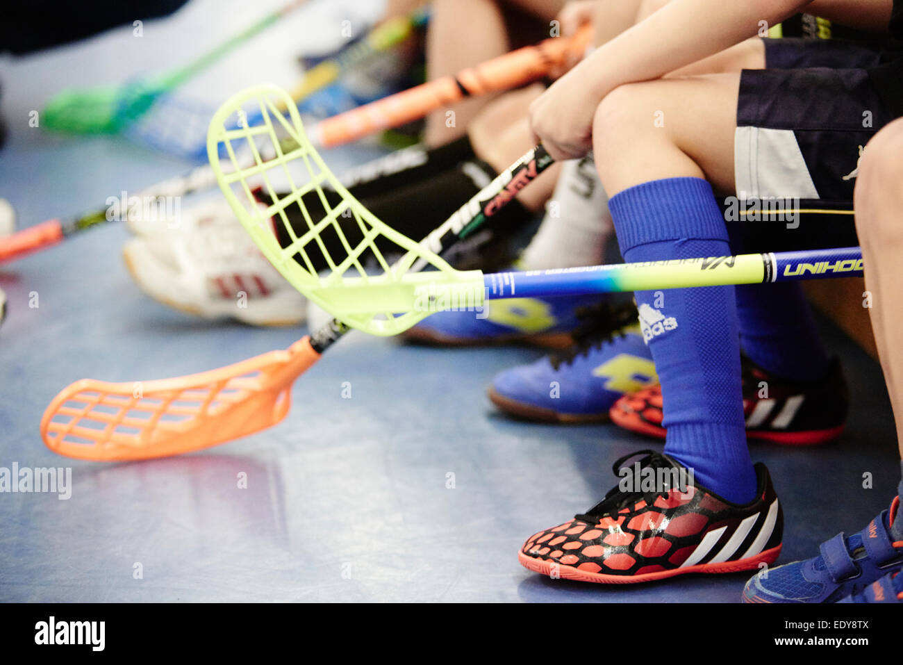 Children boys schoolchildren playing floorball (floor hockey) match in