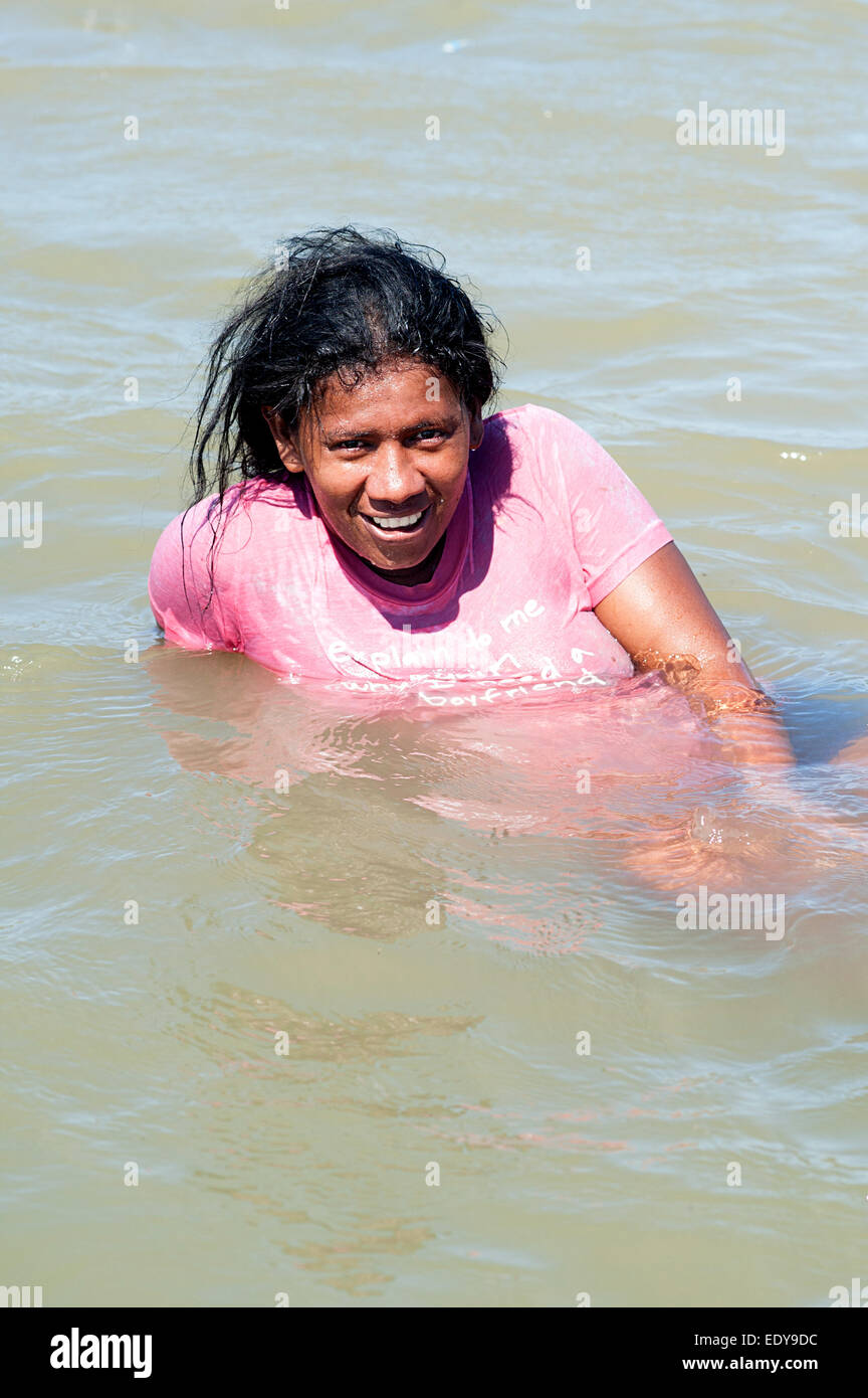 Caribbean Mum of 8 children relaxing in a saltwater lake on the coast near Caretagena Colombia. Stock Photo