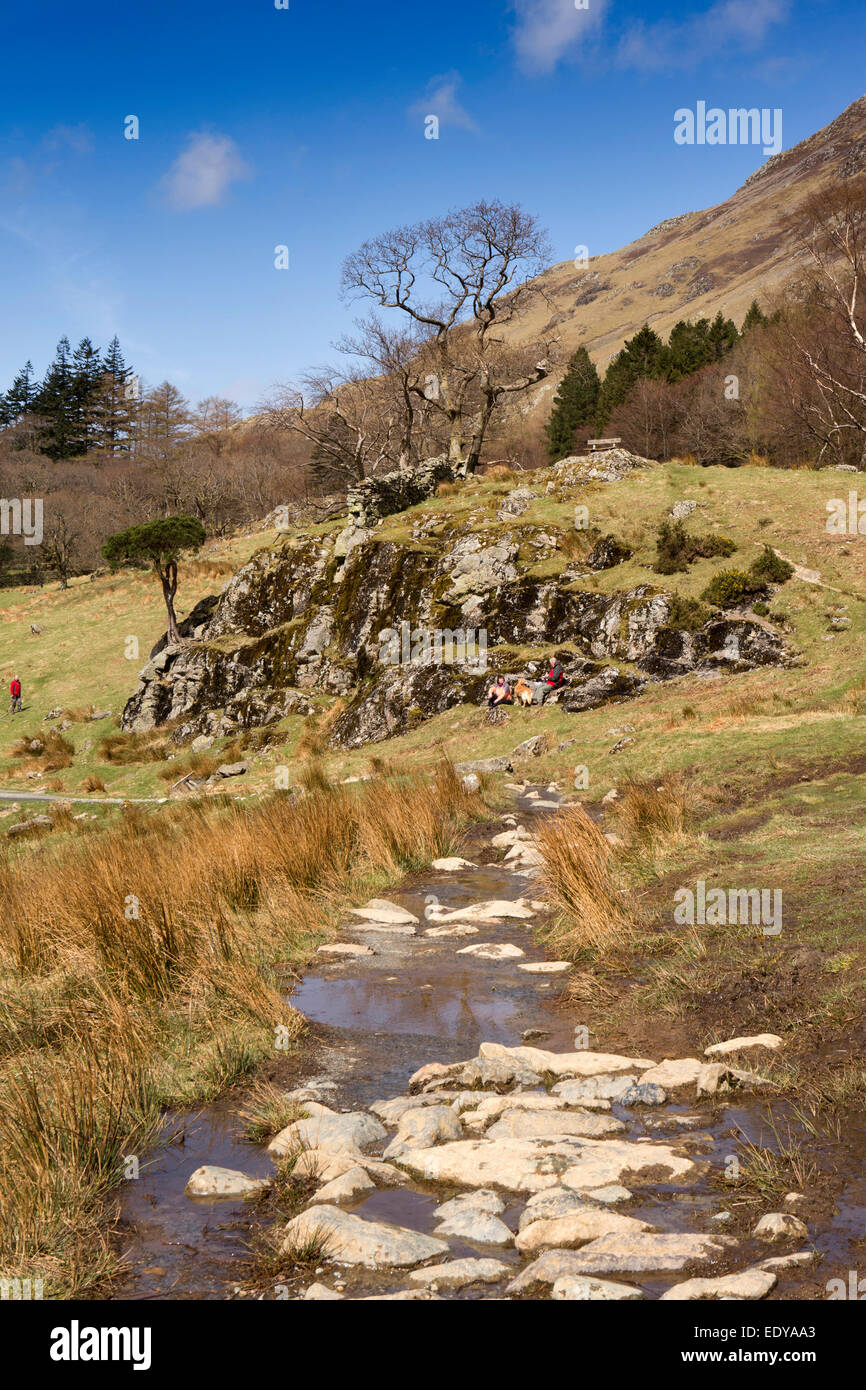 UK, Cumbria, Lake District, Buttermere, elderly walkers picknickng at bon rocks beside Crag Wood Stock Photo