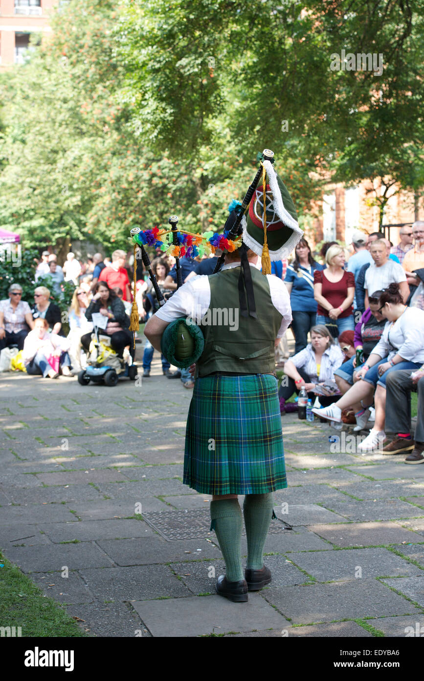 Piper plays in Sackville Gardens during the Manchester Gay Pride. Stock Photo