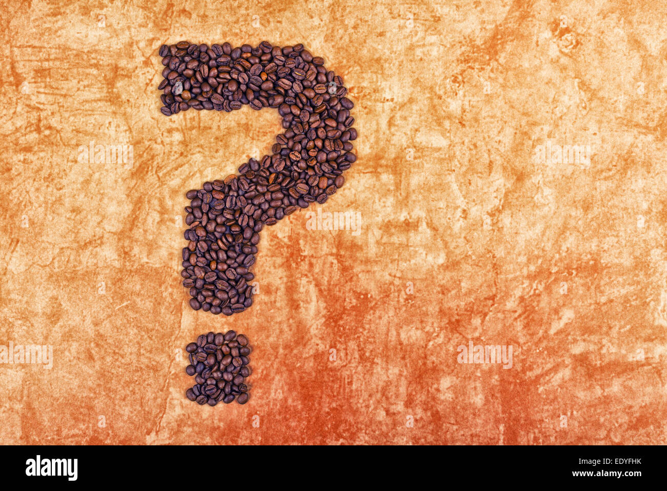 Question Mark made of Roasted Coffee Beans on grunge Background. Stock Photo
