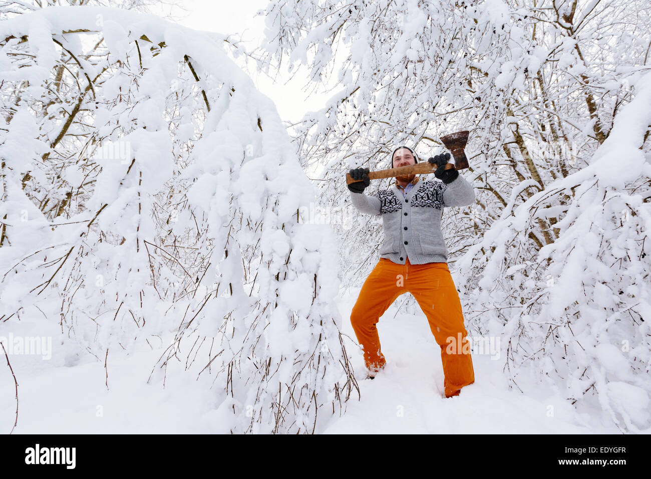 Lumberjack in the snowy winter forest Stock Photo
