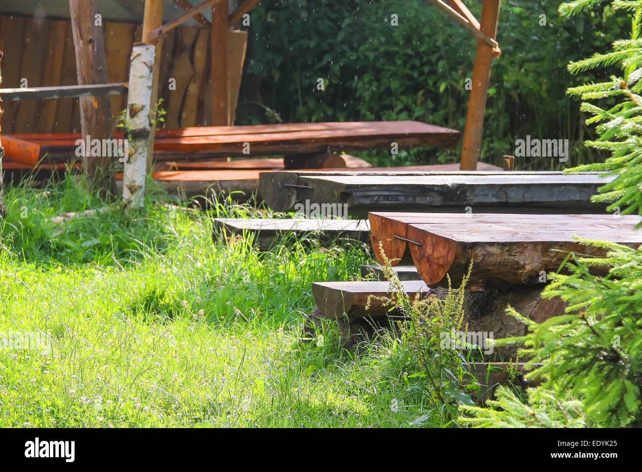 Wooden tables and benches in the gazebo at the park Stock Photo