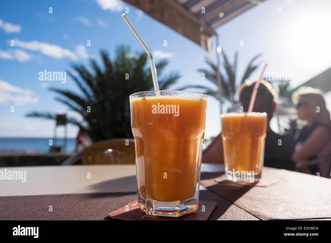 Glasses with juice, beach promenade, La Playa, Valle Gran Rey, La Gomera, Canary Islands, Spain Stock Photo