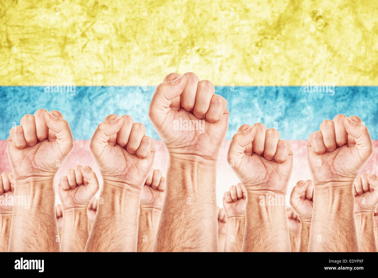 Columbia Labor movement, workers union strike concept with male fists raised in the air fighting for their rights Stock Photo