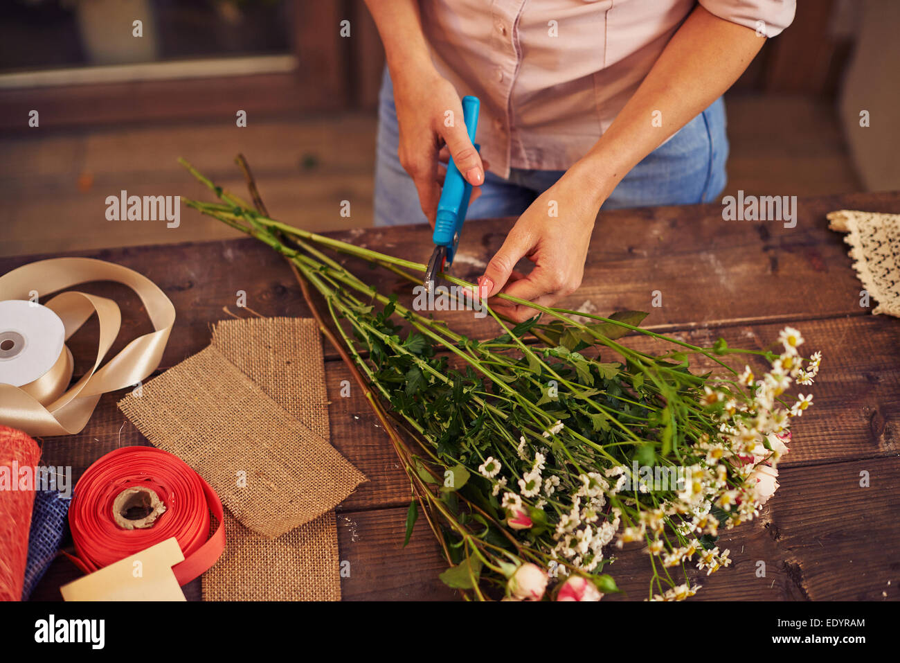Florist cutting flower stems Stock Photo