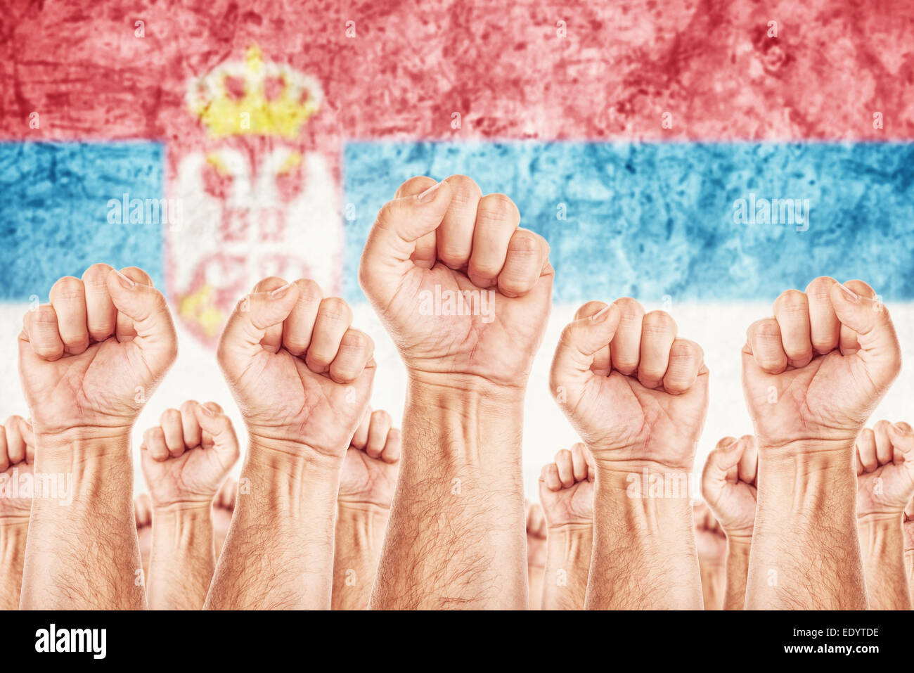 Serbia Labor movement, workers union strike concept with male fists raised in the air fighting for their rights Stock Photo