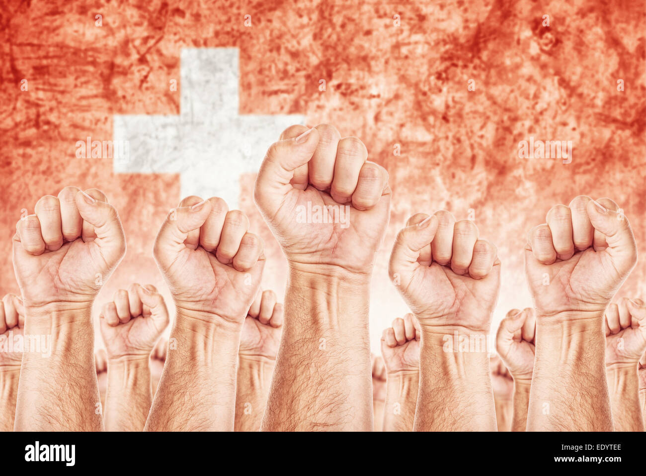 Switzerland Labor movement, workers union strike concept with male fists raised in the air fighting for their rights Stock Photo