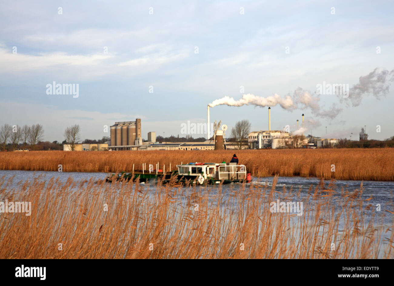 A workboat on the River Yare with the British Sugar factory in the