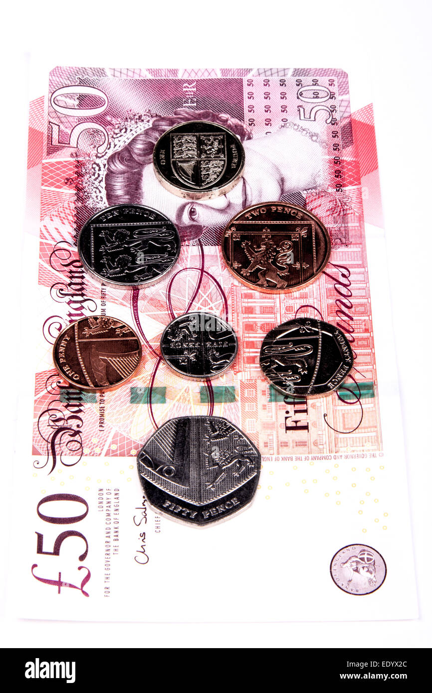 British Royal Mint Coins showing shield design on Bank of England fifty pound note Stock Photo