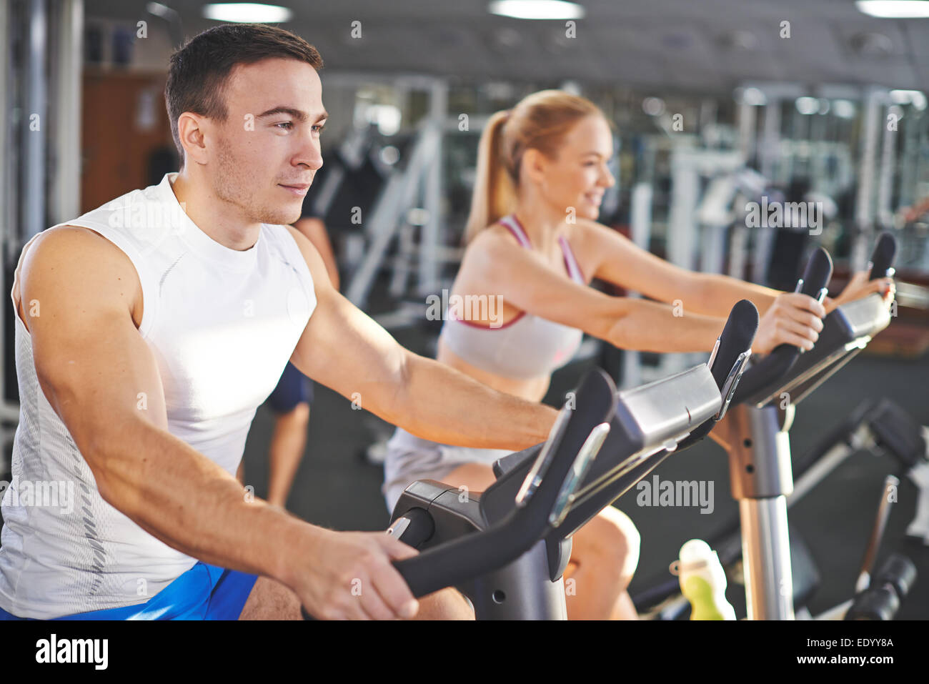 Portrait of young man and woman during workout in gym Stock Photo - Alamy