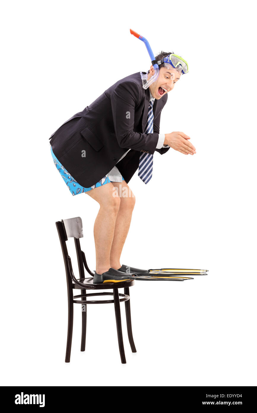 Businessman with snorkel jumping off a chair isolated on white background Stock Photo