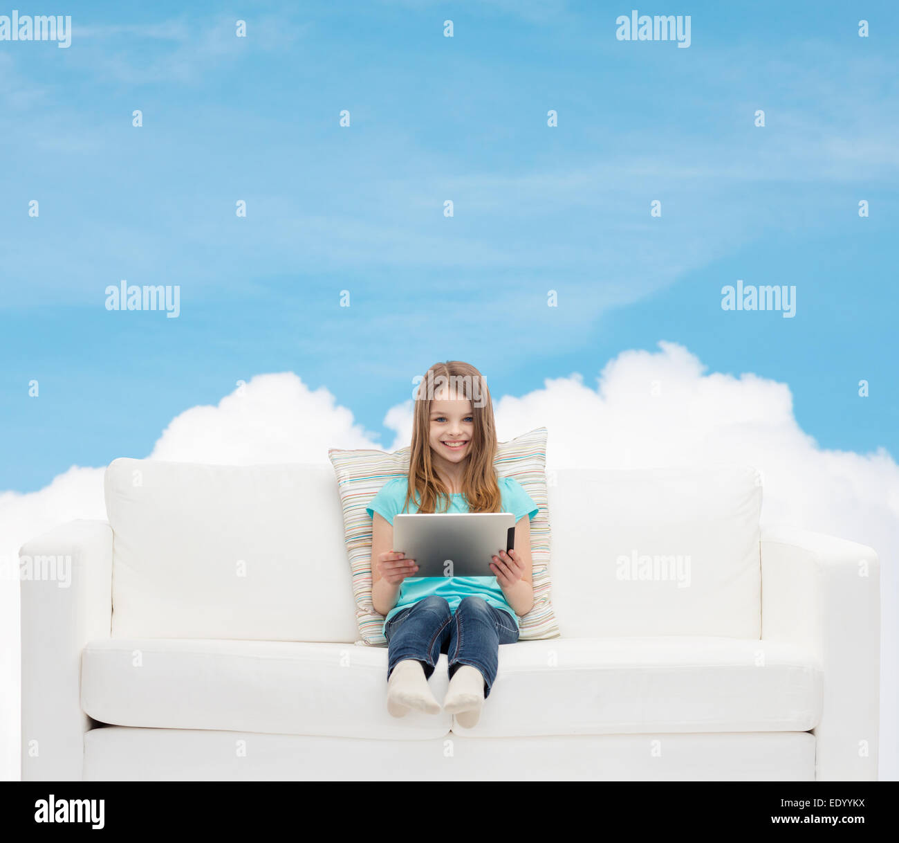 little girl sitting on sofa with tablet pc Stock Photo - Alamy