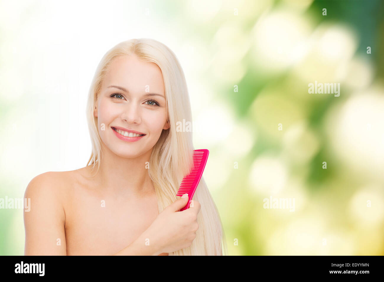 smiling woman with hair brush Stock Photo