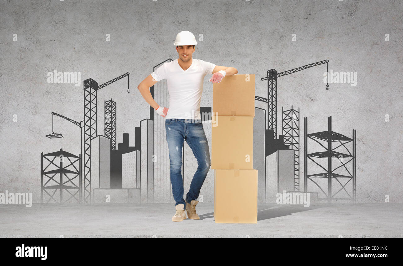 man in helmet with tower of cardboard boxes Stock Photo