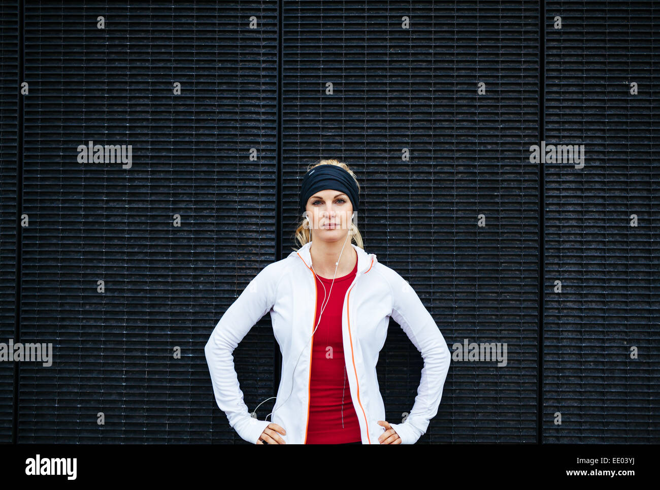 Close up portrait determined female runner stretching arms stock photo