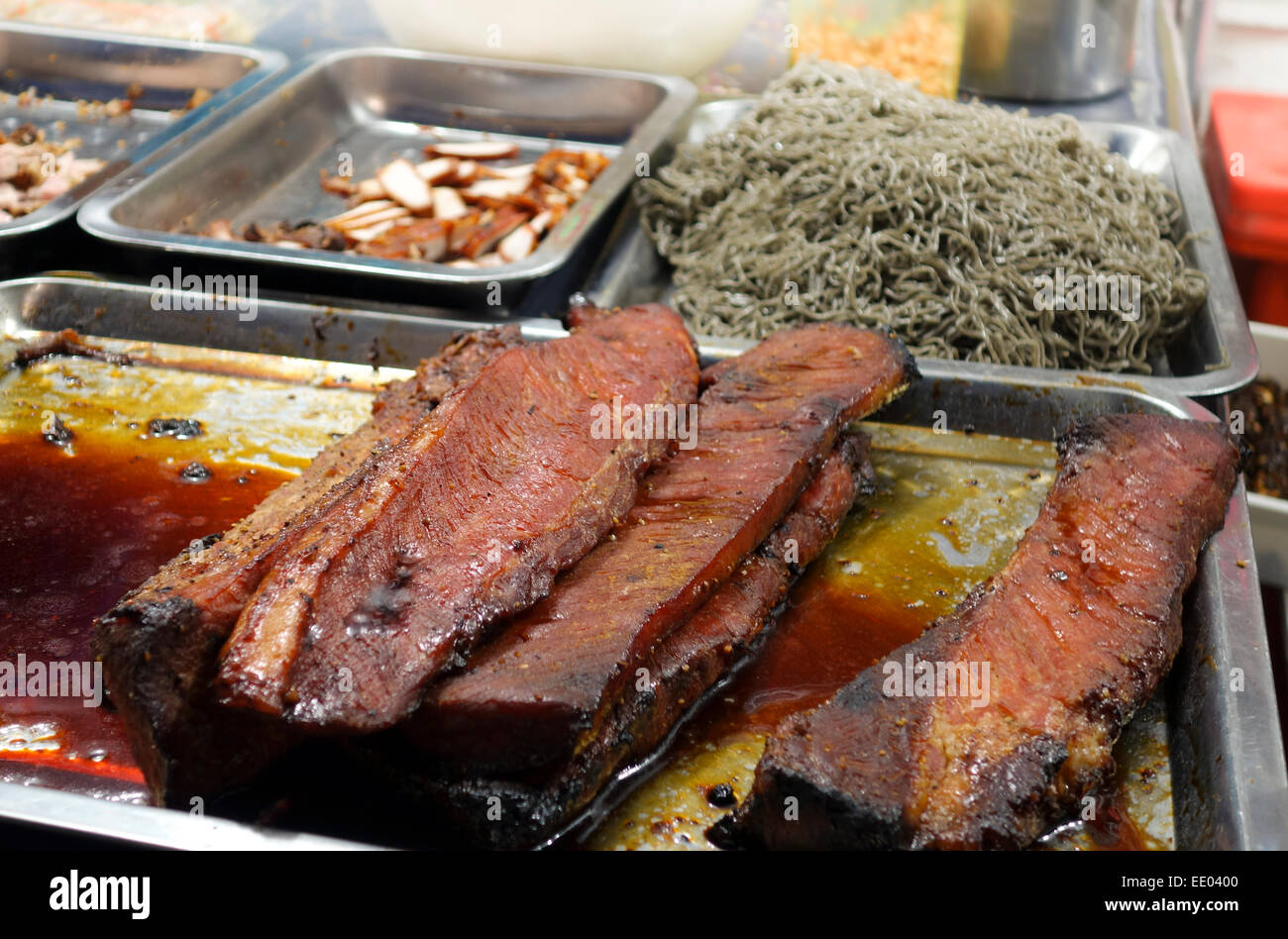 Roasted pork for sale on night street market around MBK shopping centre, Bangkok, Thailand, Southeast Asia. Stock Photo
