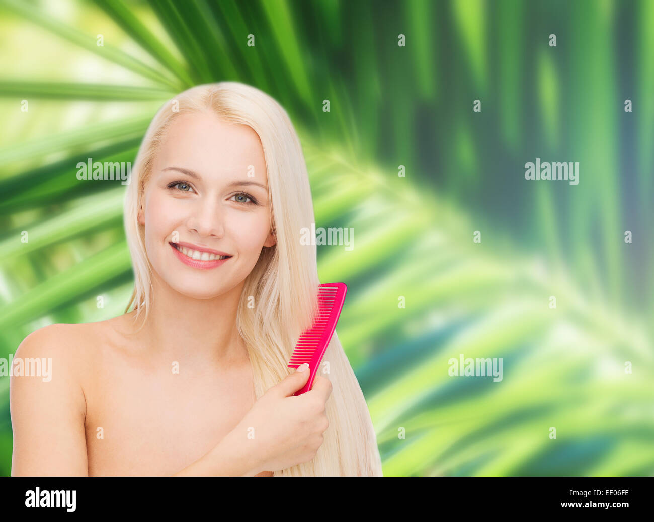 smiling woman with hair brush Stock Photo
