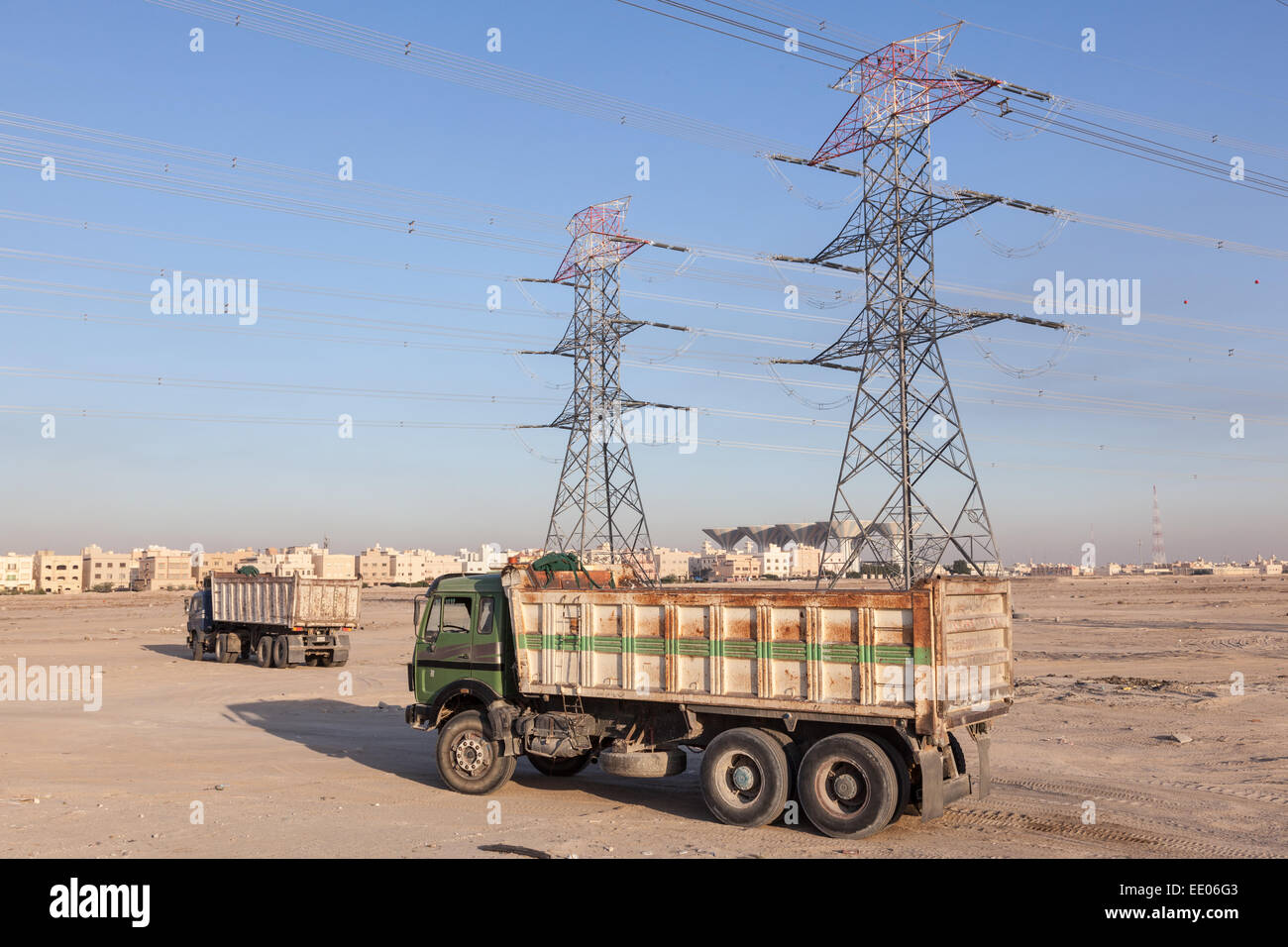 High voltage power lines and trucks in Kuwait, Middle East Stock Photo