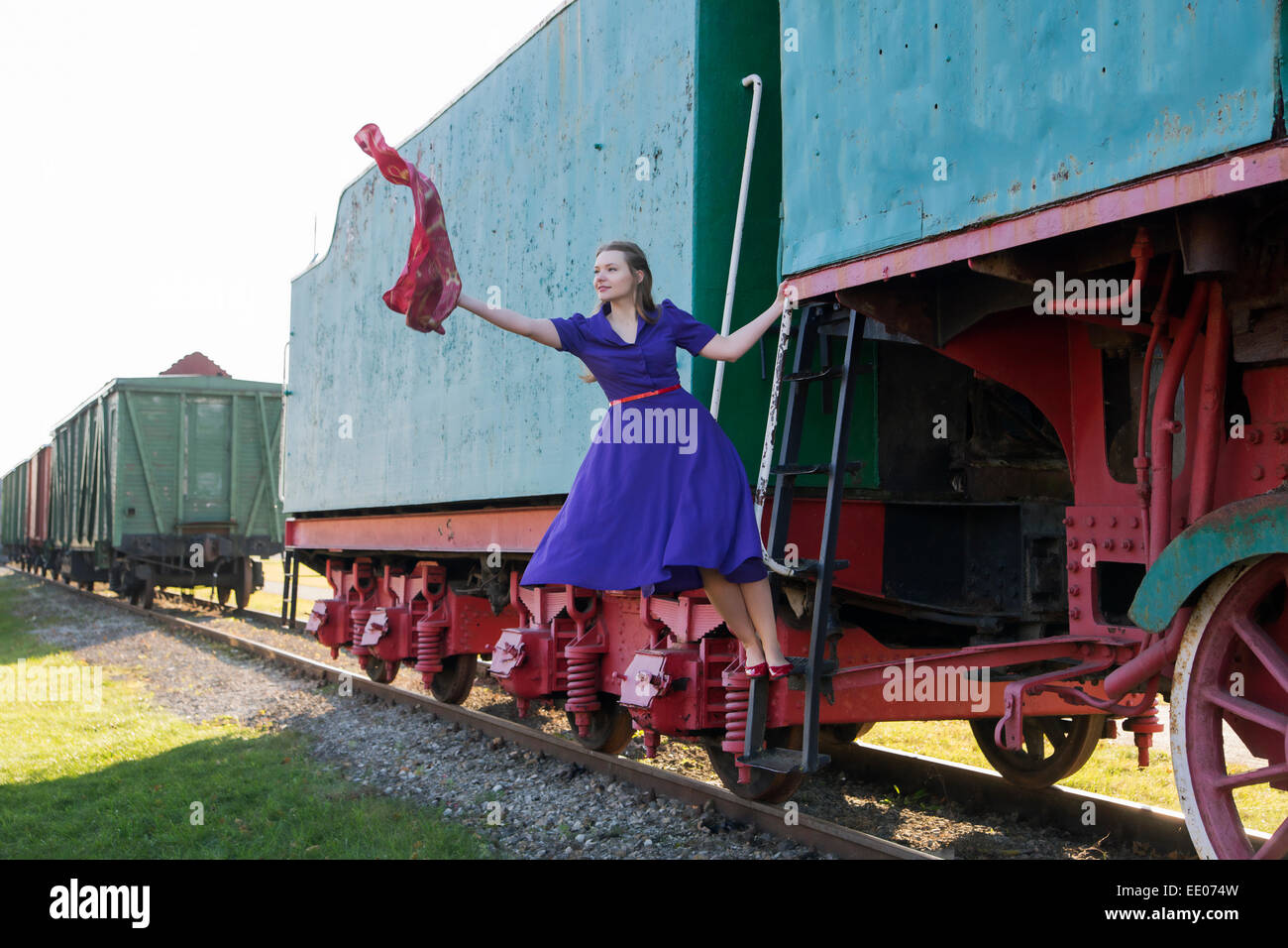 Woman at lilac dress and waving a scarf Stock Photo