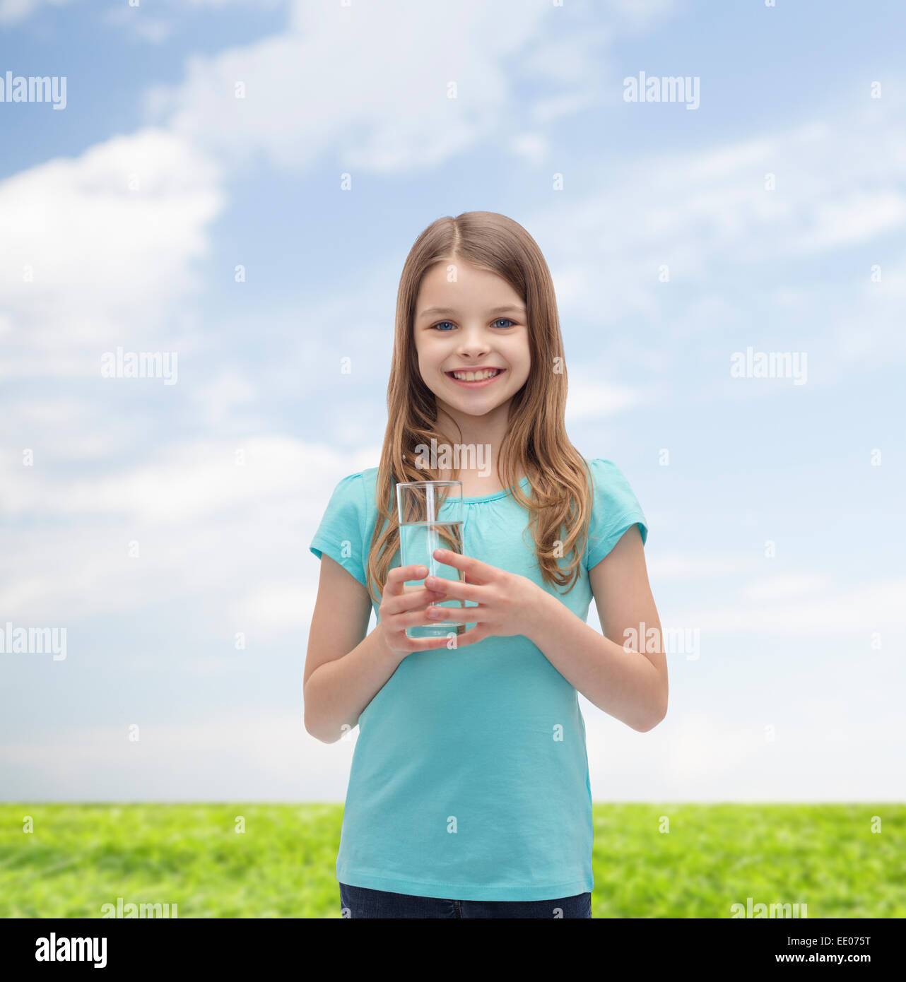 smiling little girl with glass of water Stock Photo - Alamy