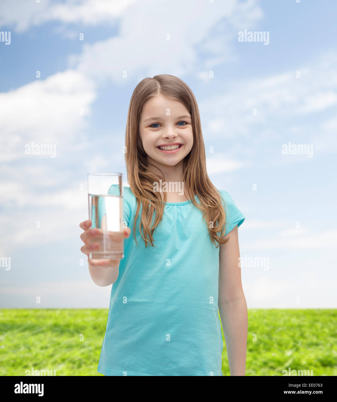 smiling little girl giving glass of water Stock Photo - Alamy