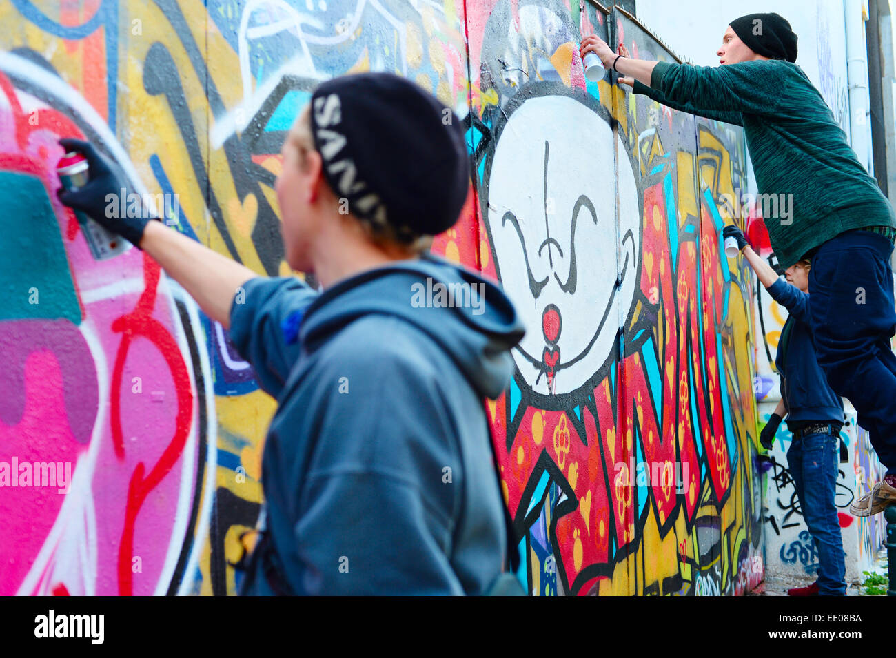 Male teen painting wall spray paint hi-res stock photography and images