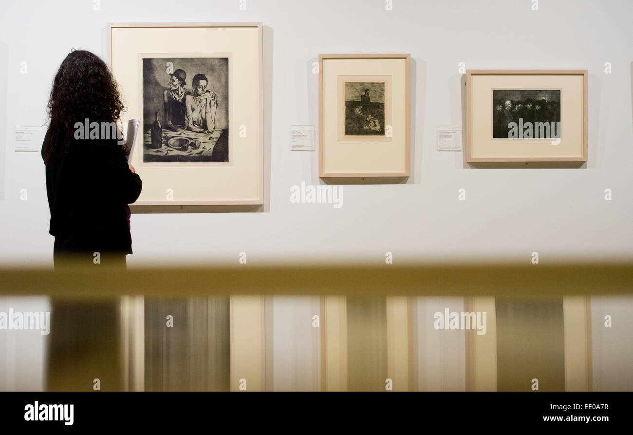 A woman stands in front of work from Kaethe Kollwitz and Pablo Picasso at the exhibition 'Before Modernism. Art Around 1900 from the Graphics Collection' at the Sprengel Museum in Hanover, Germany, 11 January 2015. Photo: JULAIN STRATENSCHULTE/dpa Stock Photo