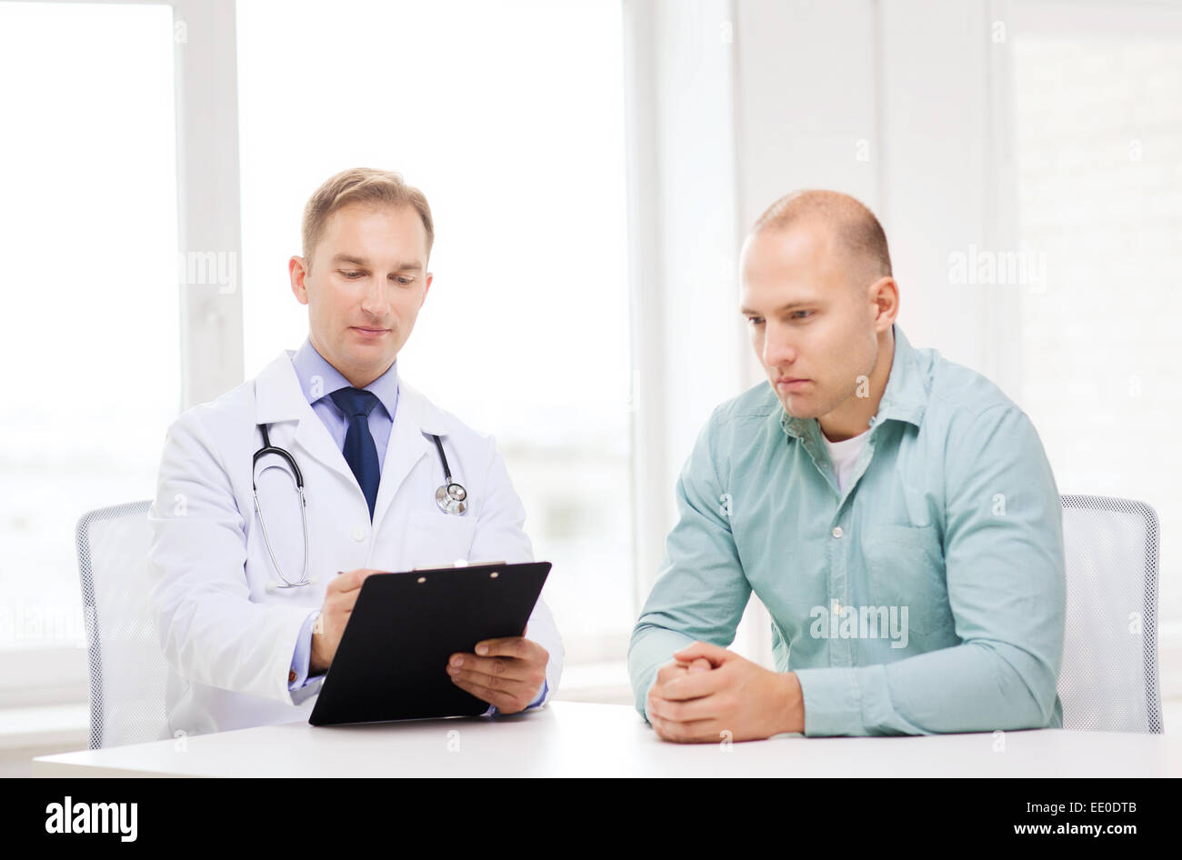 doctor with clipboard and patient in hospital Stock Photo - Alamy