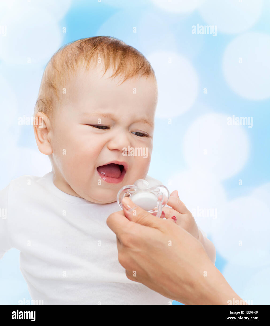 crying baby with dummy Stock Photo