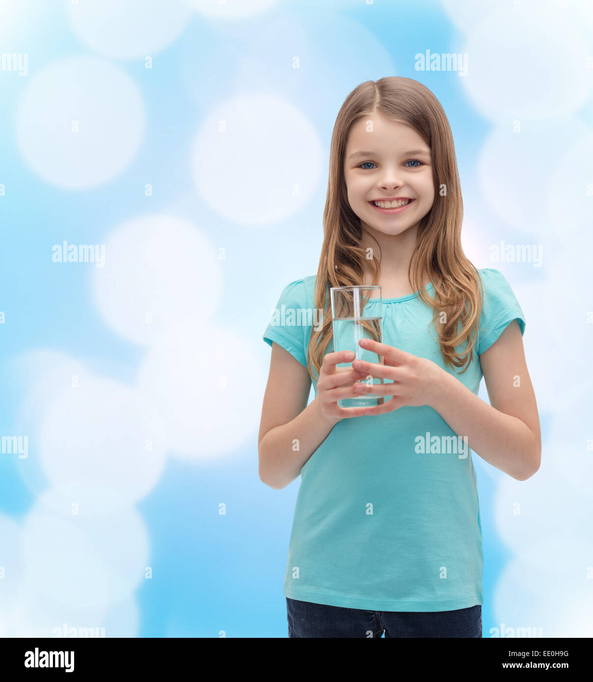 smiling little girl with glass of water Stock Photo - Alamy