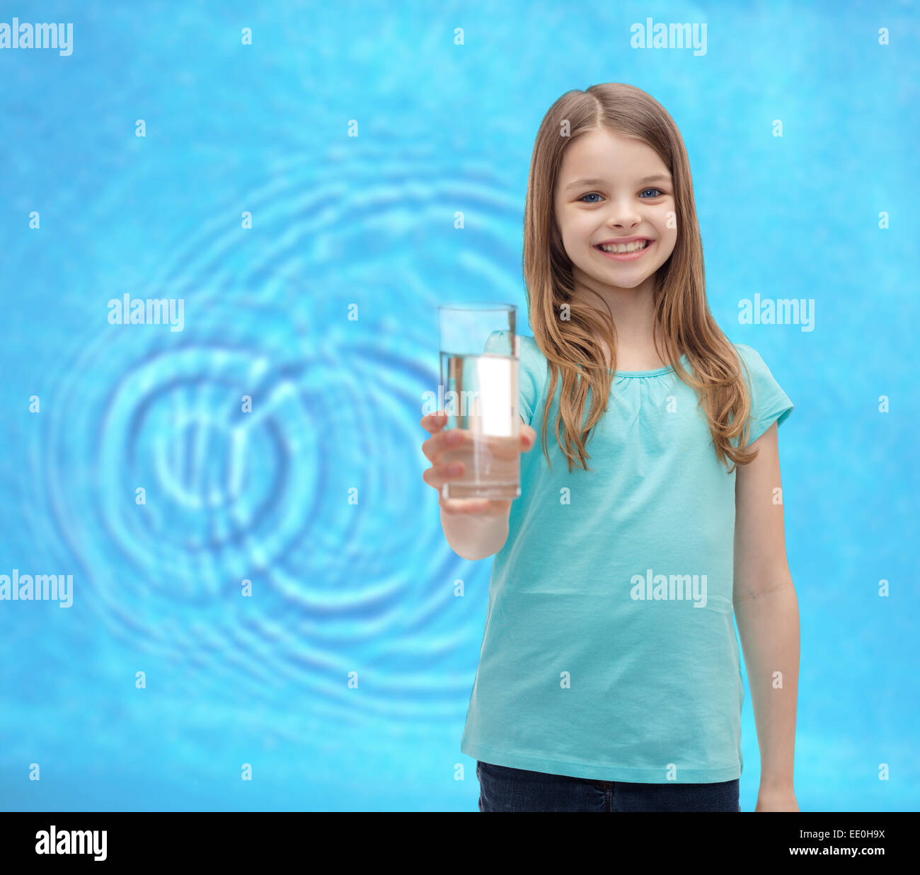 smiling little girl giving glass of water Stock Photo - Alamy