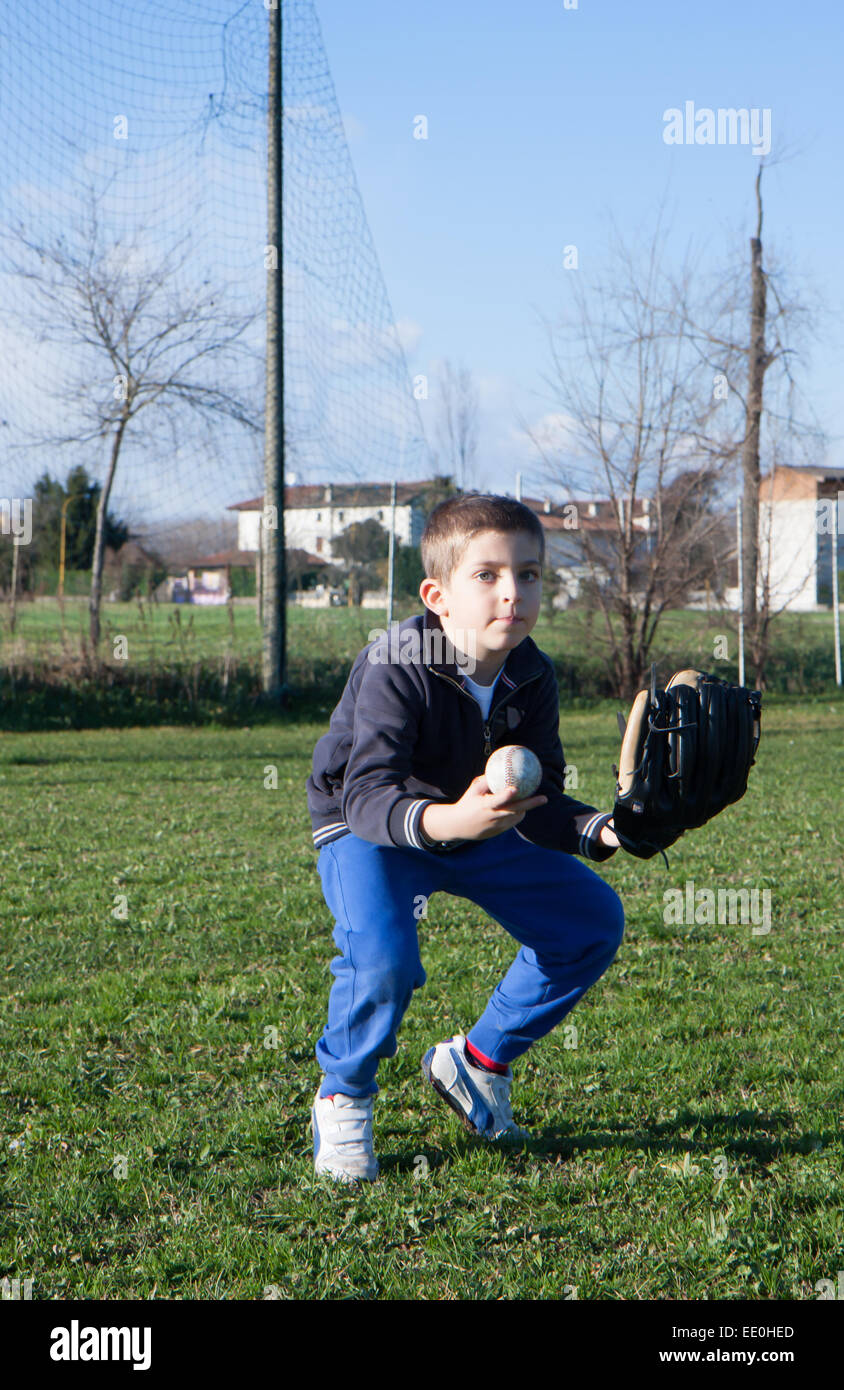 child to the park with glove that is playing baseball Stock Photo