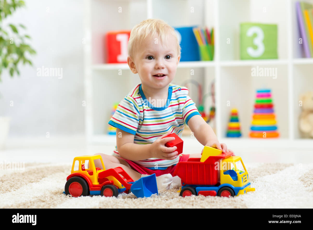 child boy playing with toy car Stock Photo
