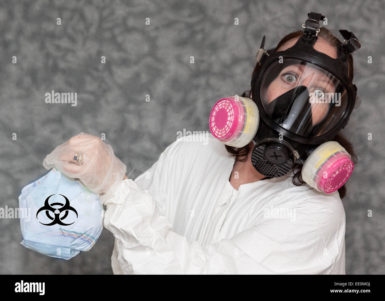 Concerned Woman with Gas Mask, gloves and Lab Coat holding Trash with Bio Hazard Symbol Stock Photo